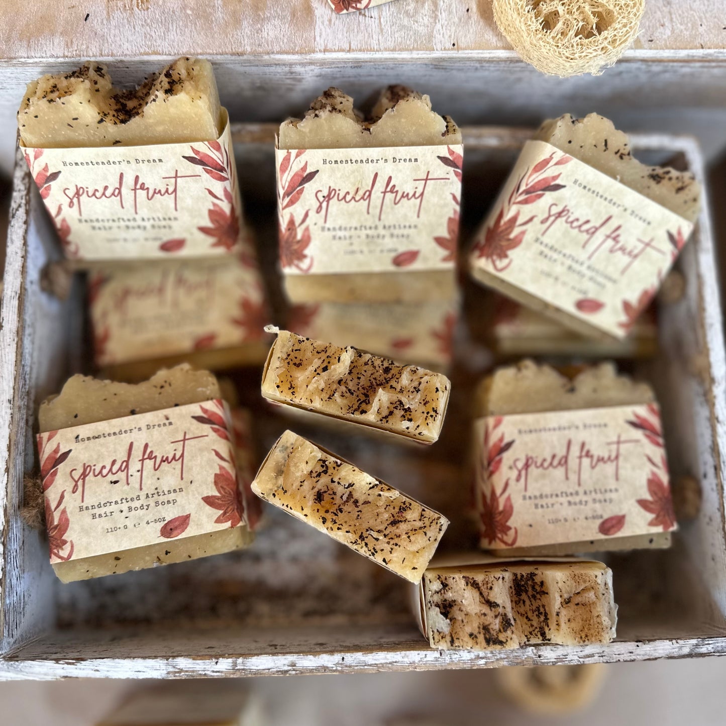 Bar soaps with 'Spiced Fruit' packaging in a rustic container