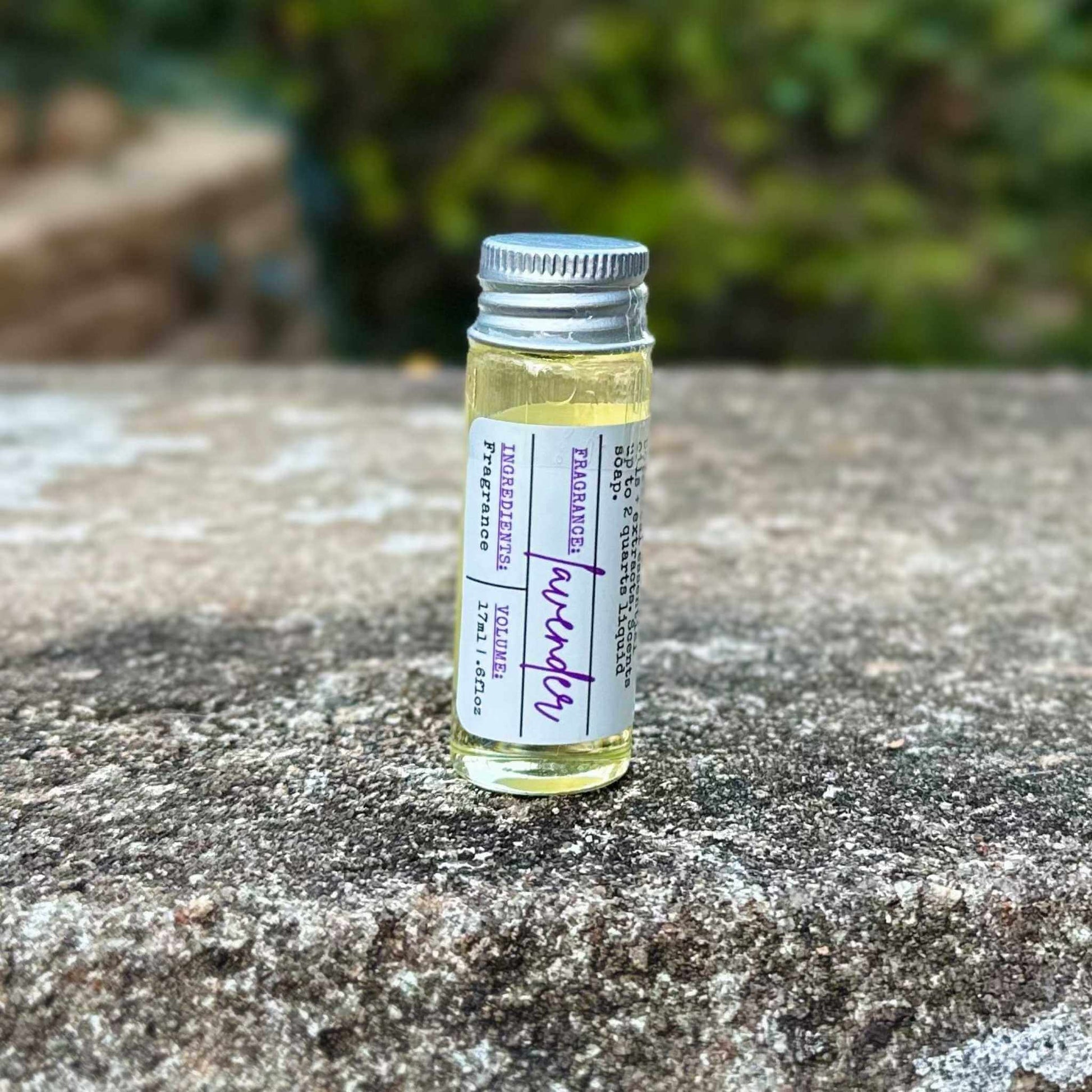 Small glass vial with a label on a stone surface outdoors