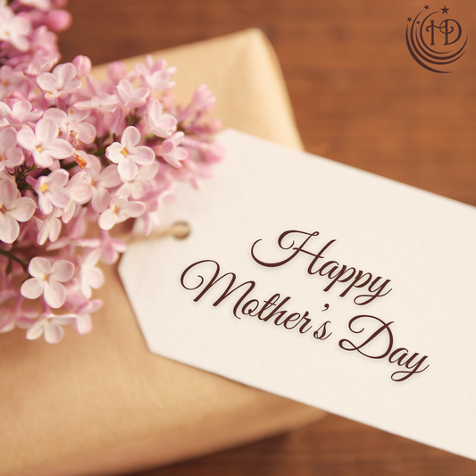 happy Mother's Day tag attached to gift wrapped in brown paper with pink hydrangeas