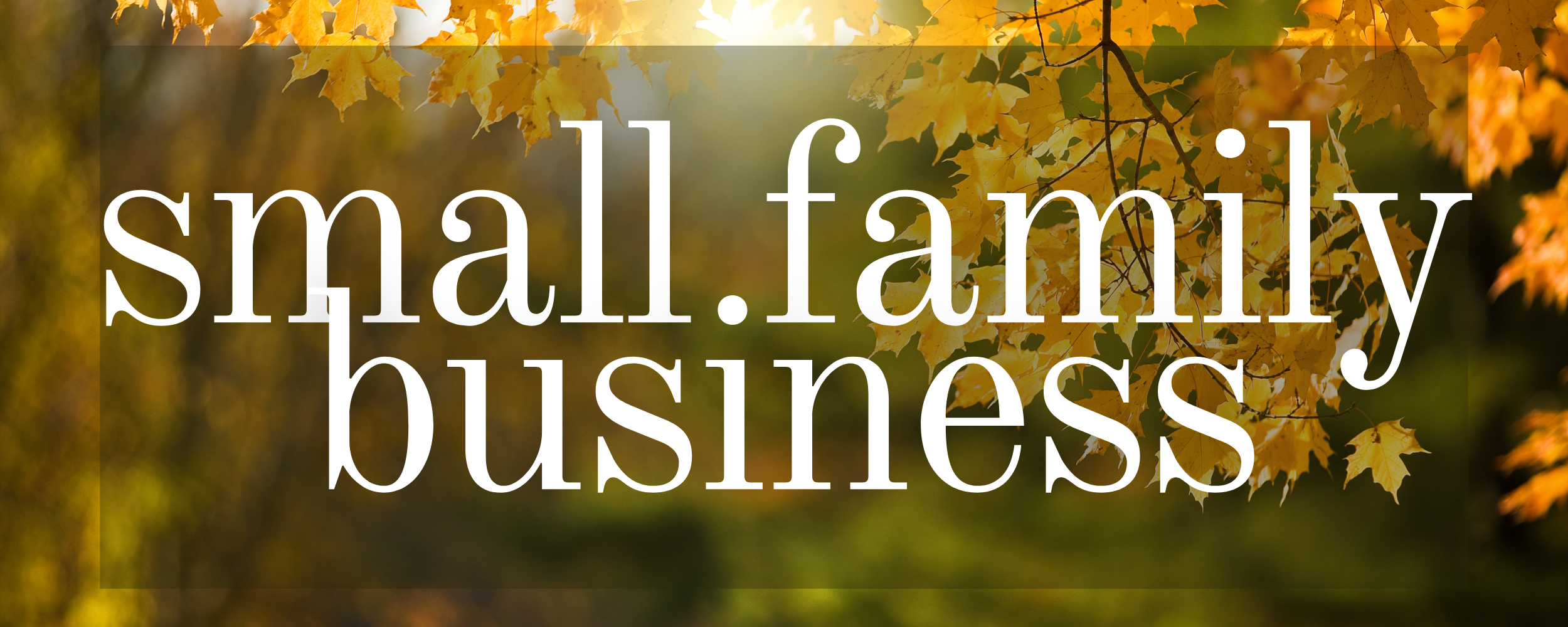 Text 'small.family business' with a blurred autumn leaf background