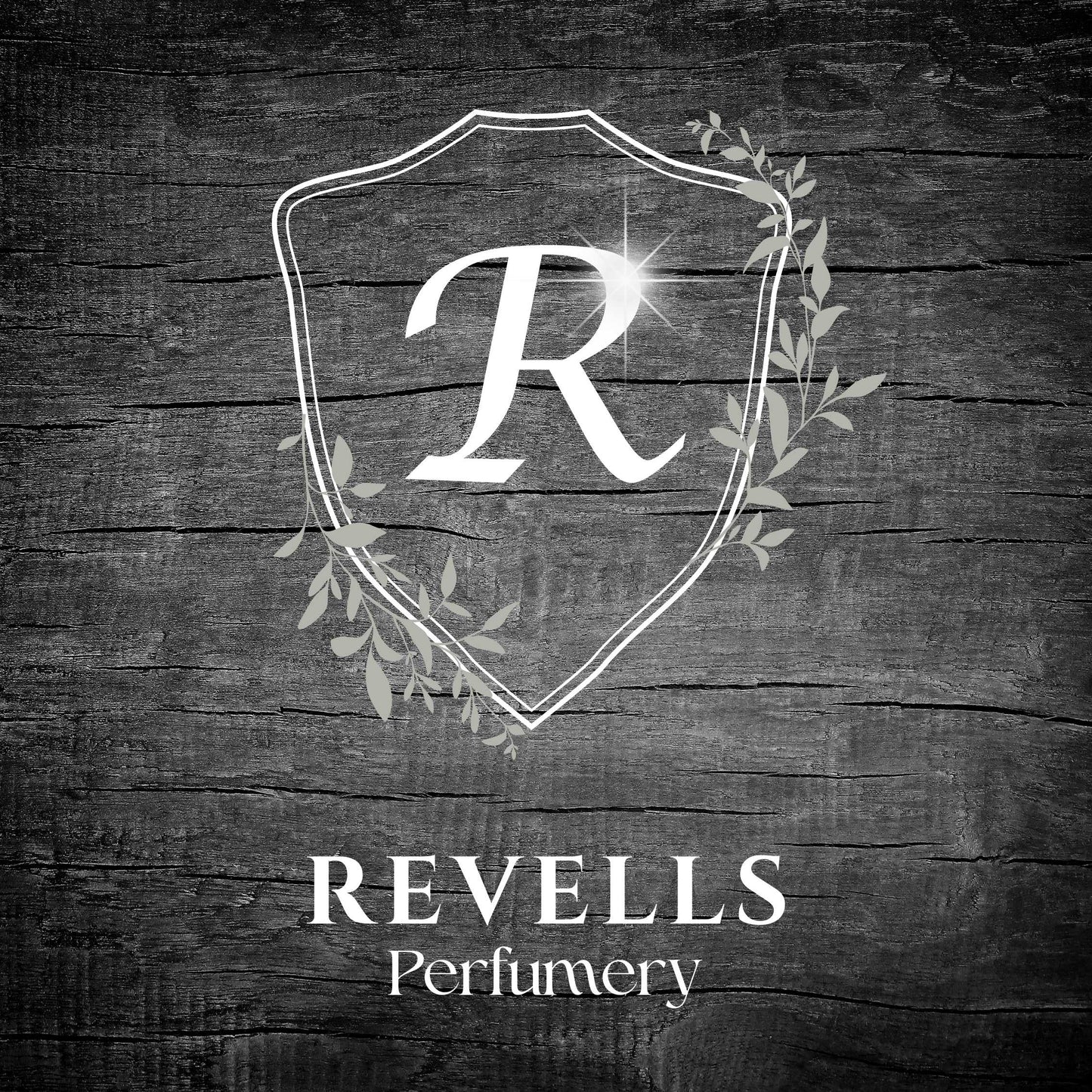Revells Perfumery logo on a wooden background
