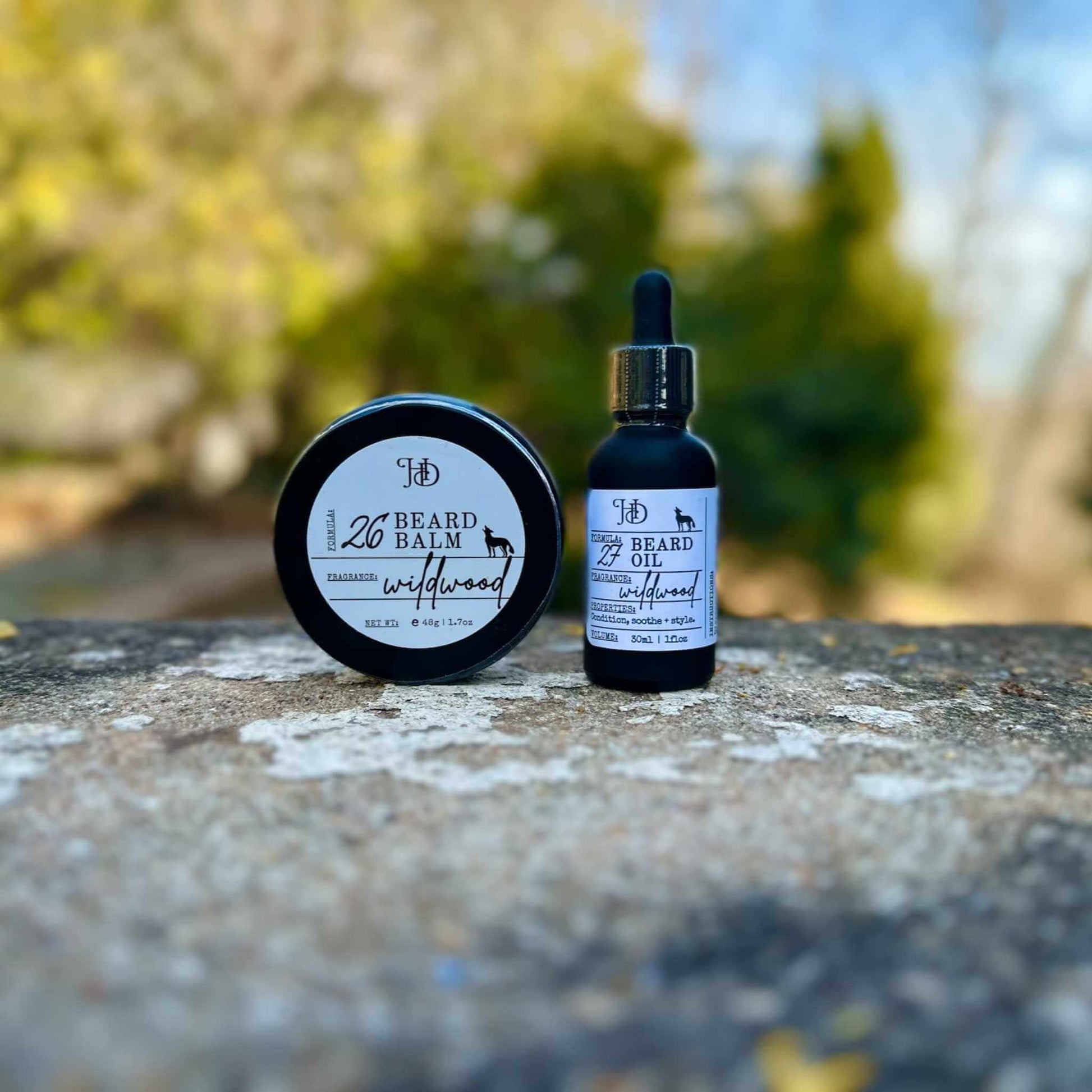 Beard balm and oil with dropper on a stone surface outdoors