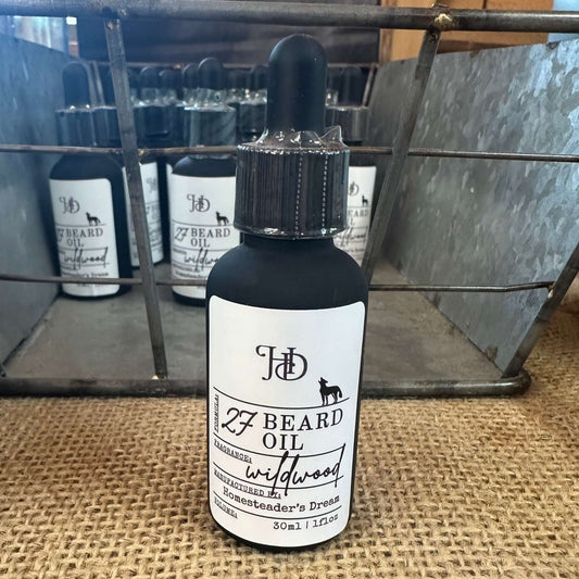 Bottle of Formula #27 Beard Oil with a dropper on a burlap surface.