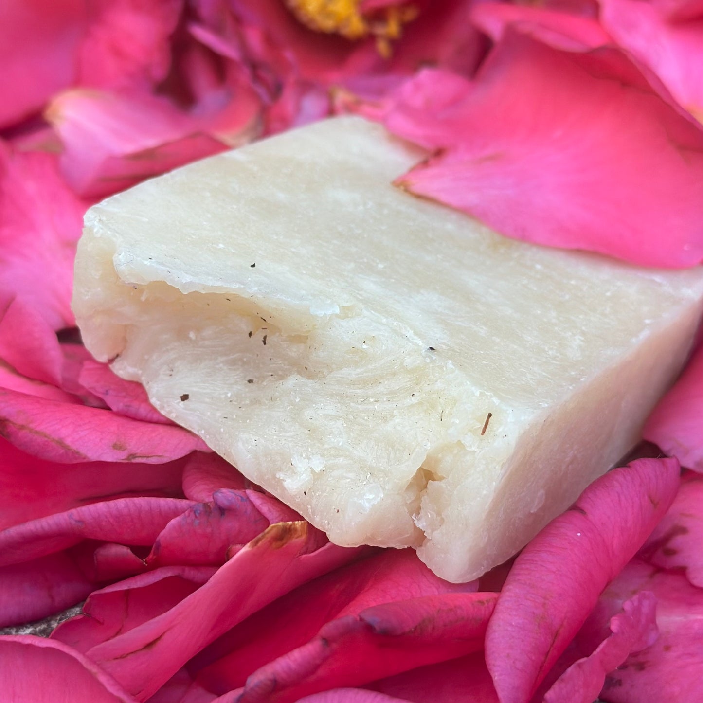 closeup of rose shea hair and body soap on a bed of pink petals
