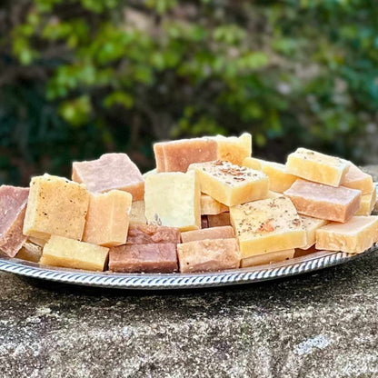Assorted pieces of guest soap on a silver platter with a natural background