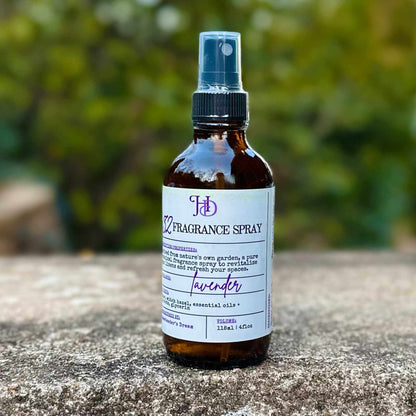 Bottle of lavender fragrance spray on a stone surface with a blurred green background