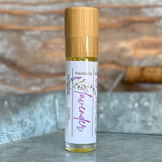 Roll-on bottle of lavender perfume oil with a bamboo cap on a galvanized tray.