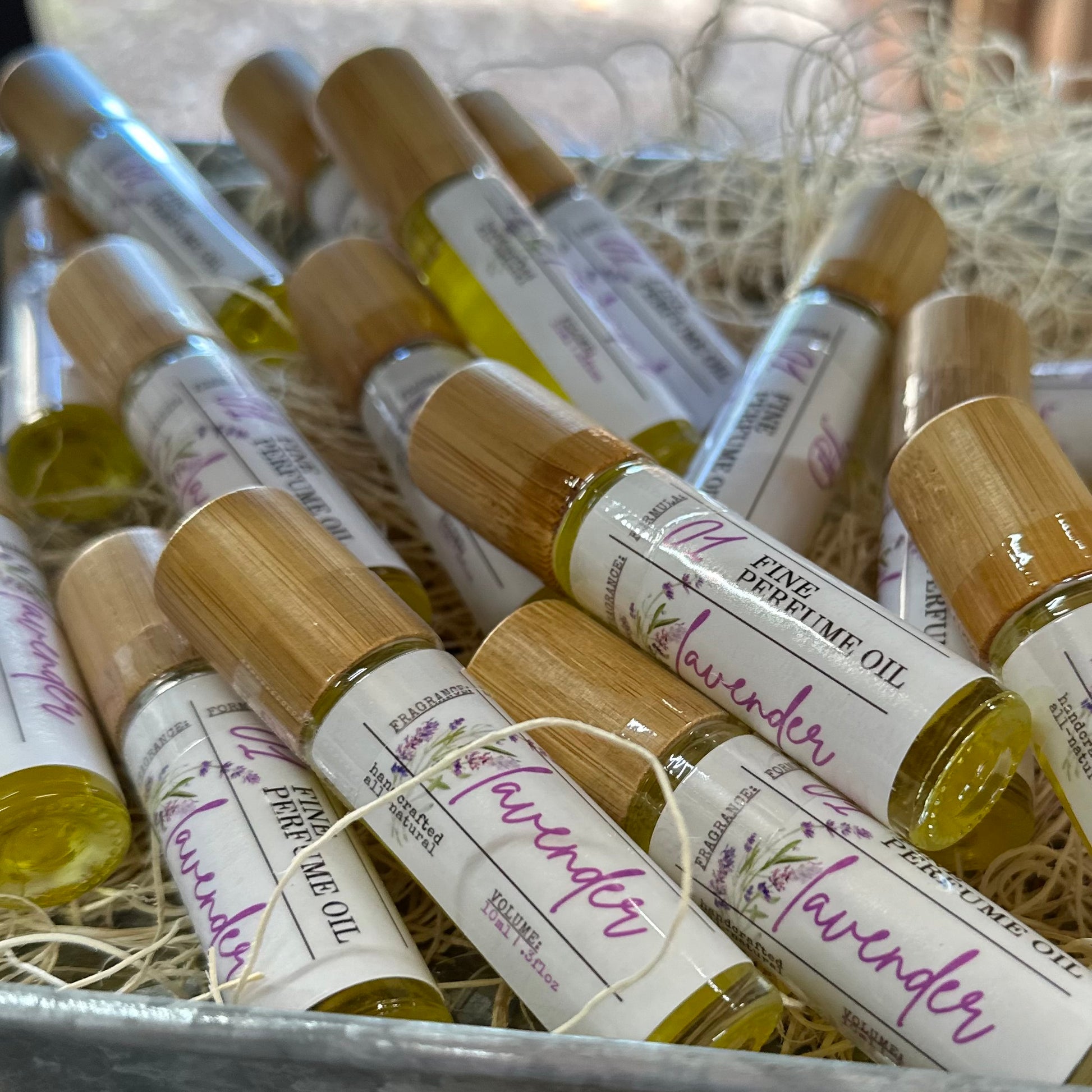 Roll-on bottles of lavender perfume oil on a rustic surface
