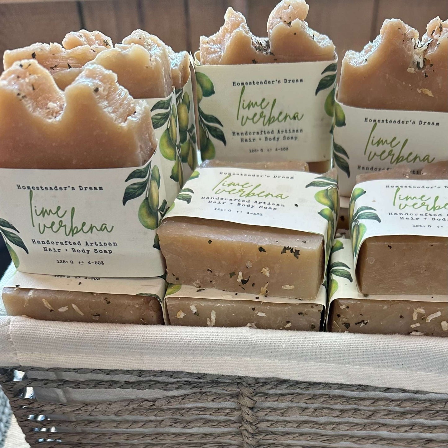 Handcrafted lime verbena soap bars in a woven basket.