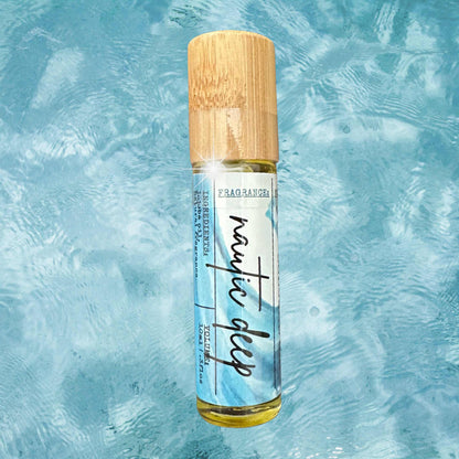 Roll-on cologne bottle with wooden cap on a textured blue background