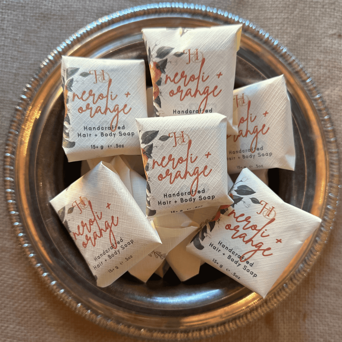 silver bowl of neroli + orange guest soaps