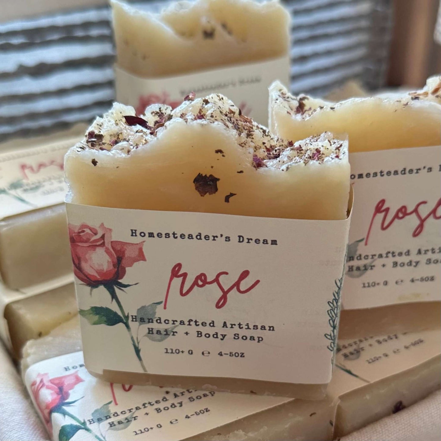 romantic rose handcrafted artisan soap bars with 'Homesteader's Dream' branding and rose design on packaging.