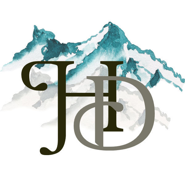 Homesteader's Dream monogram logo over a sapphire mountain