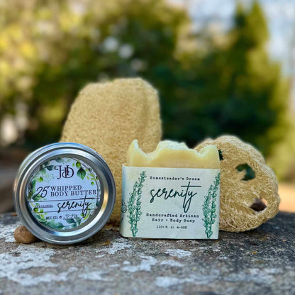 Body care products including a jar, bar of soap, and loofah on a stone surface with a blurred natural background.