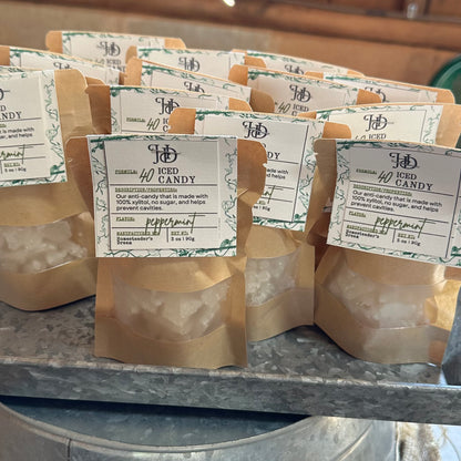 display of packs of iced candy with labels on a metal tray