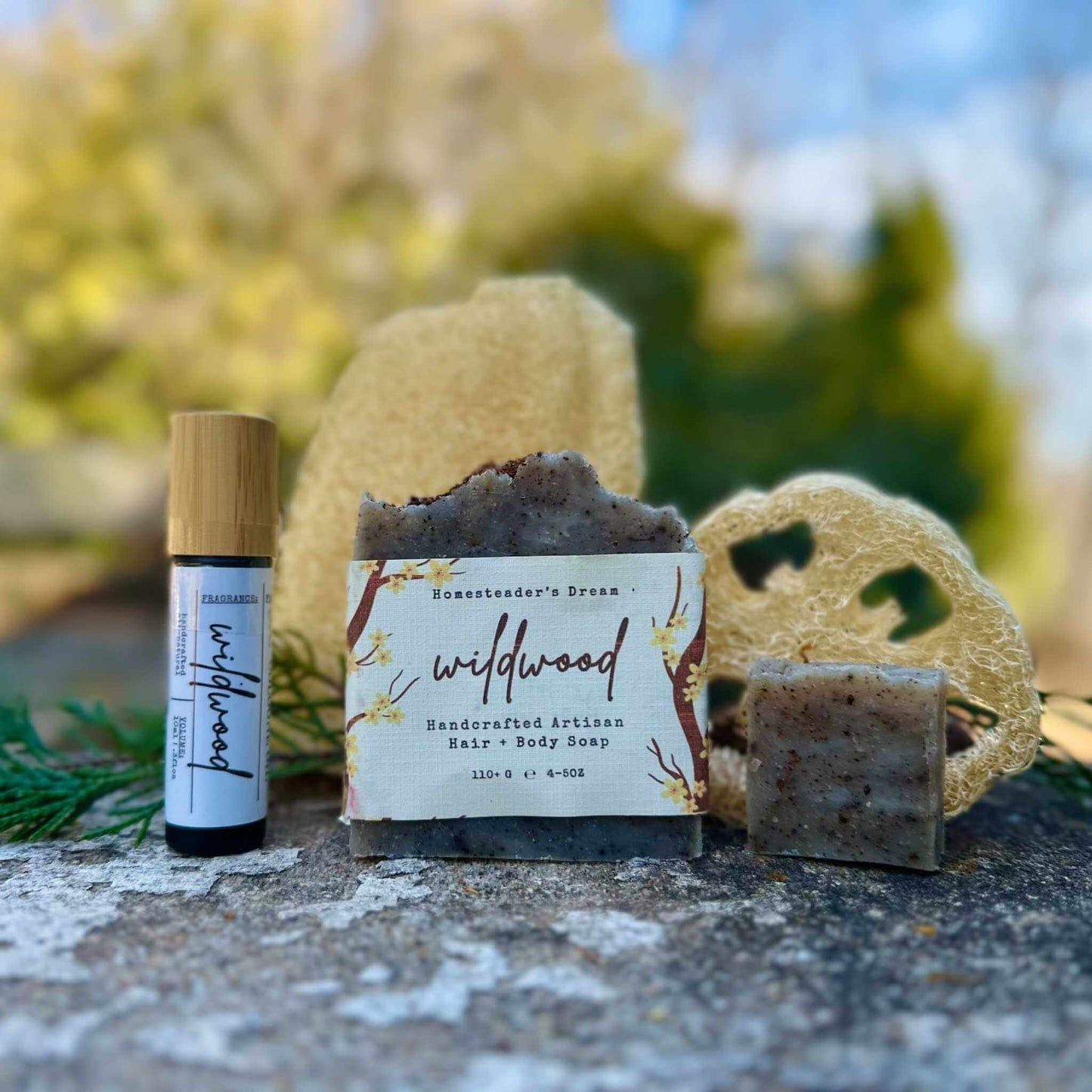 Wildwood soap bar with a cologne and loofah on a natural background